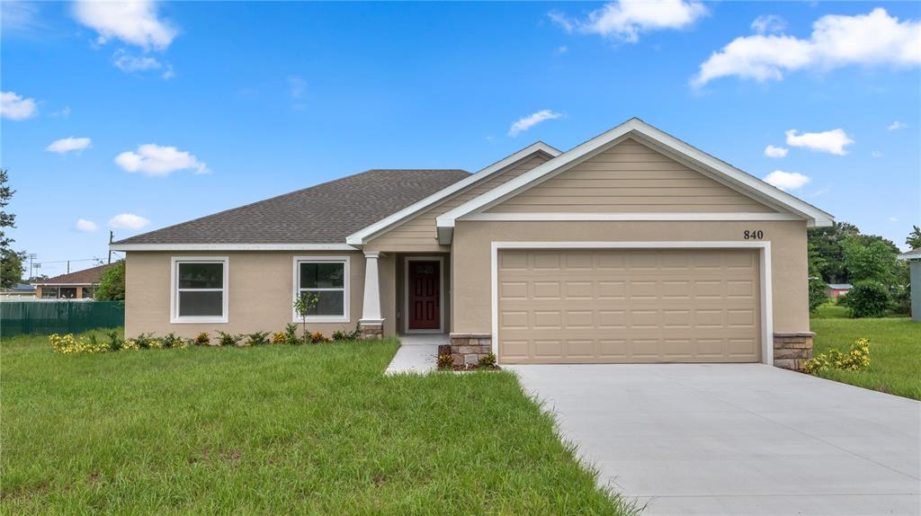 a front view of house with yard and green space