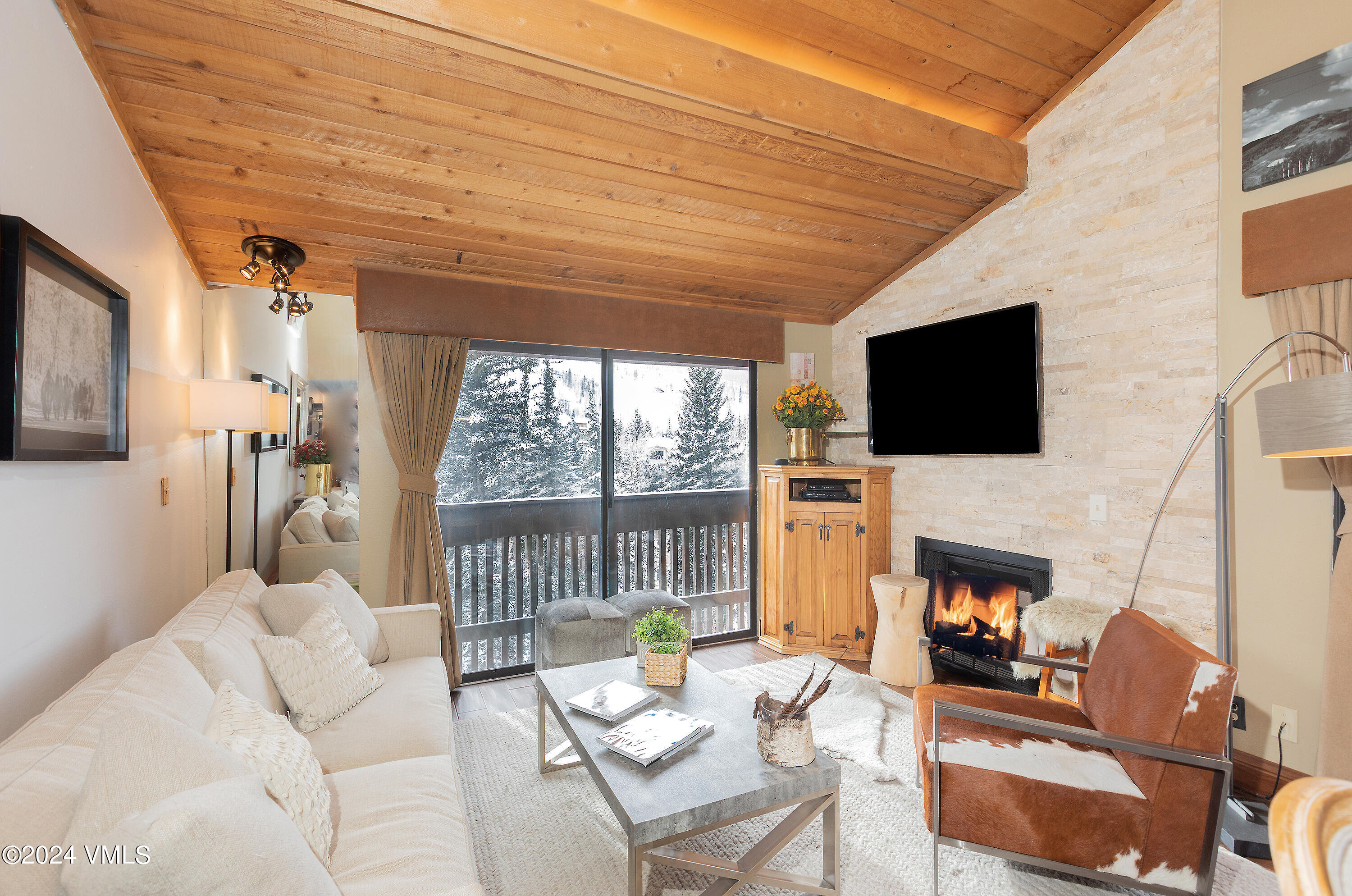 a living room with fireplace furniture and a flat screen tv