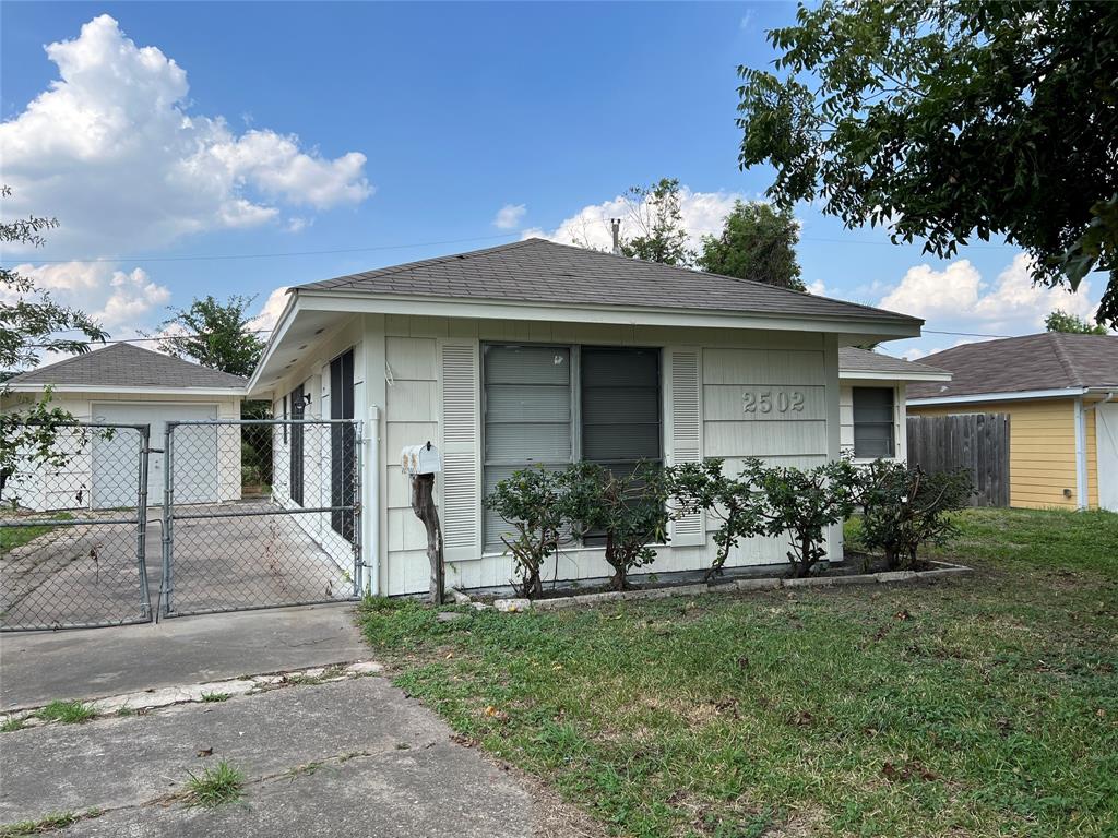 a front view of a house with a yard and outdoor seating