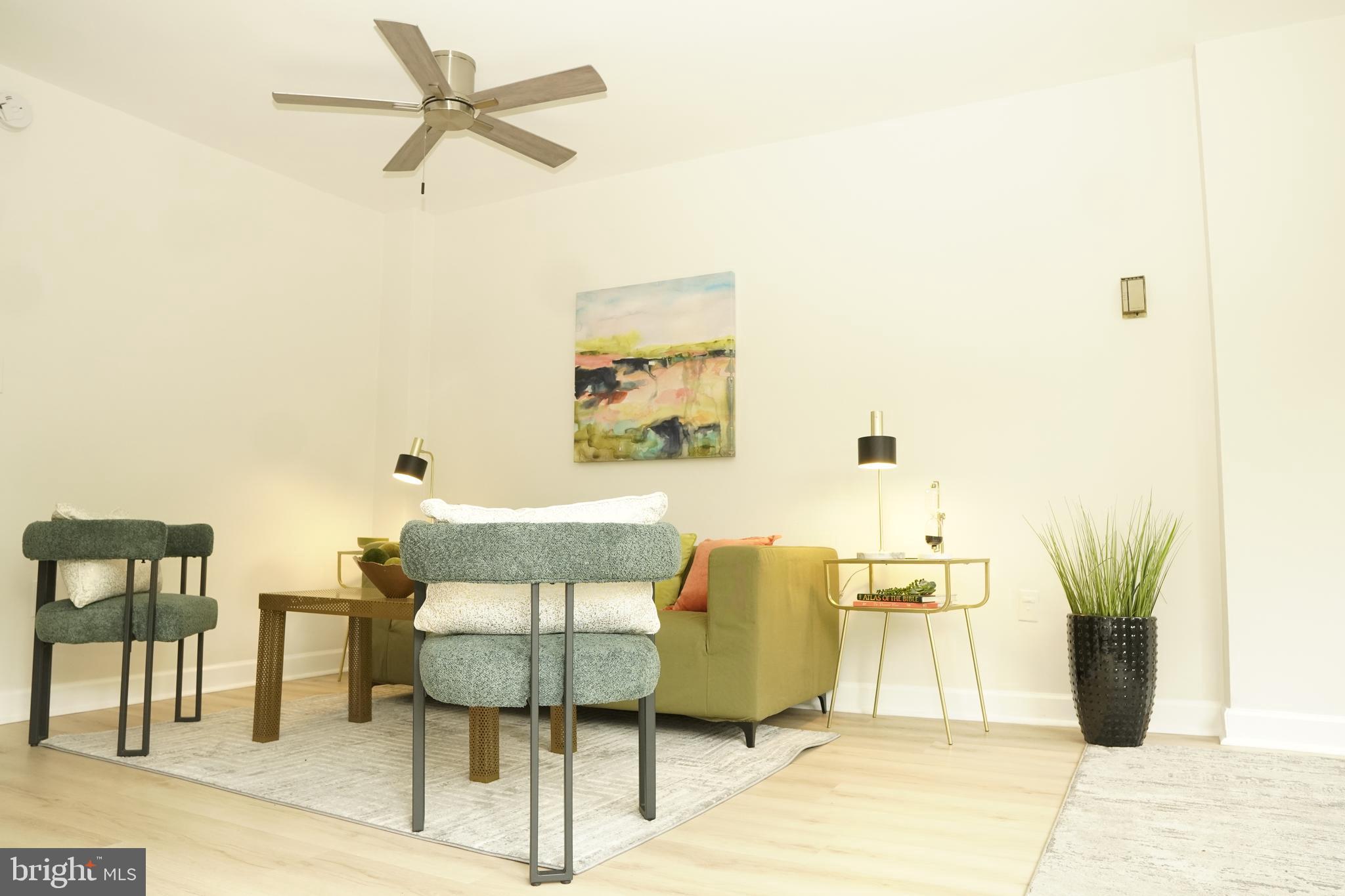 a living room with a couch and a potted plant