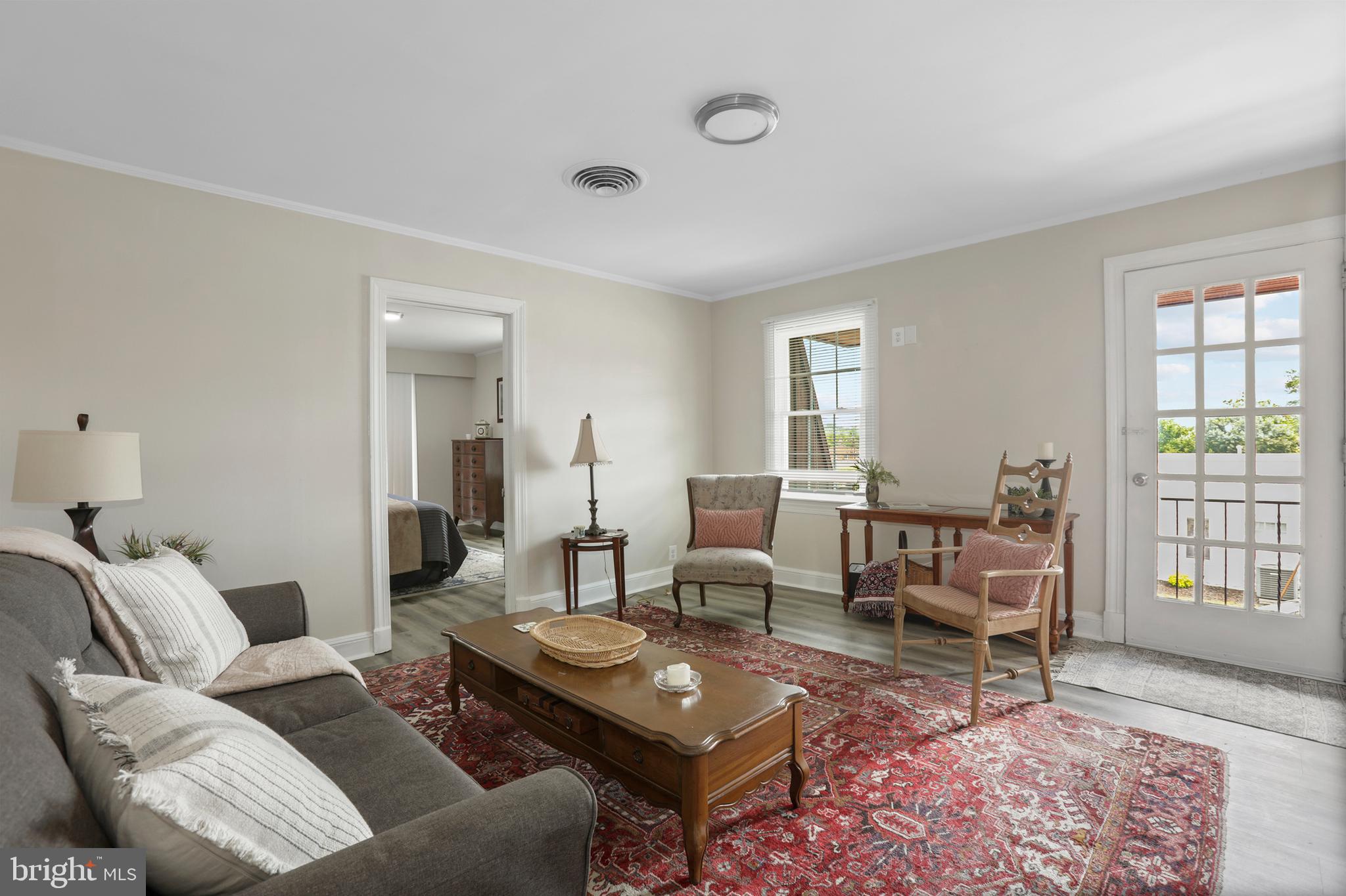 a living room with furniture and wooden floor