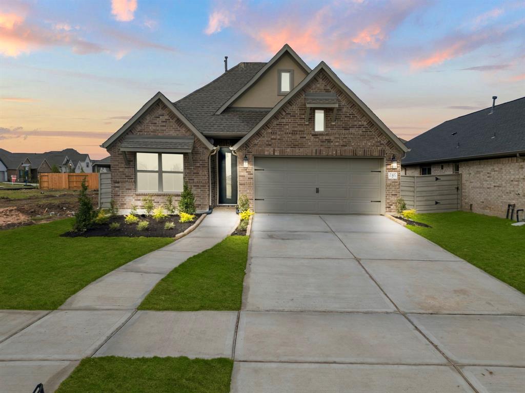 a front view of house with yard and green space