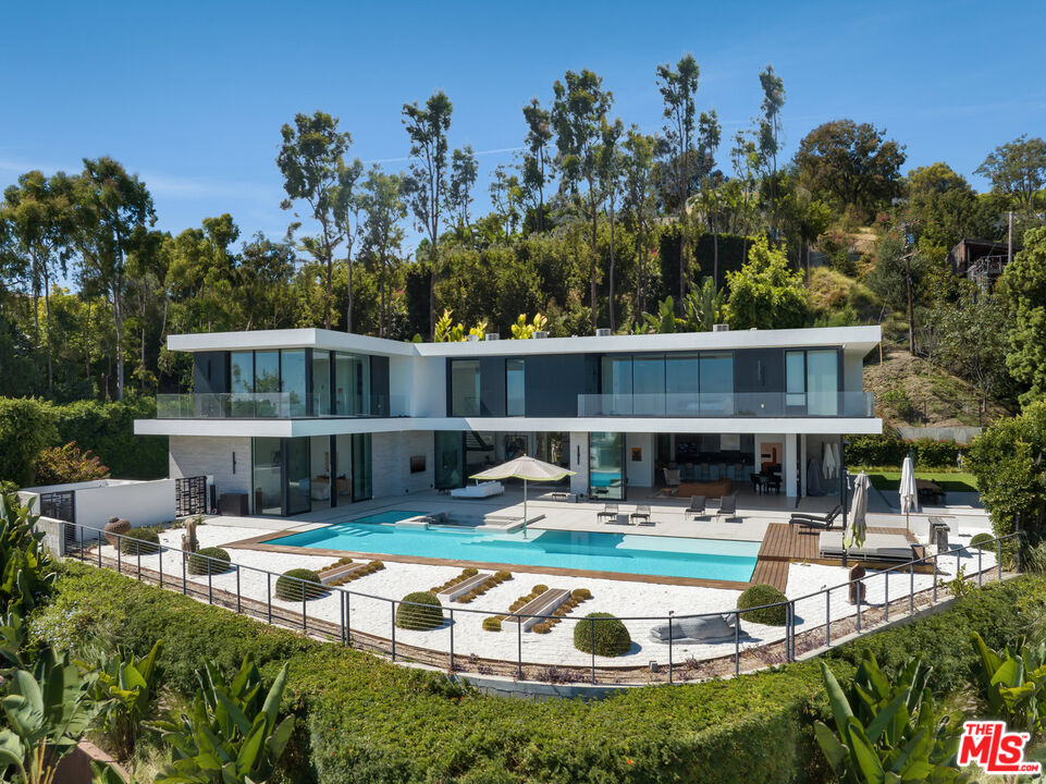 a swimming pool with outdoor seating and yard view