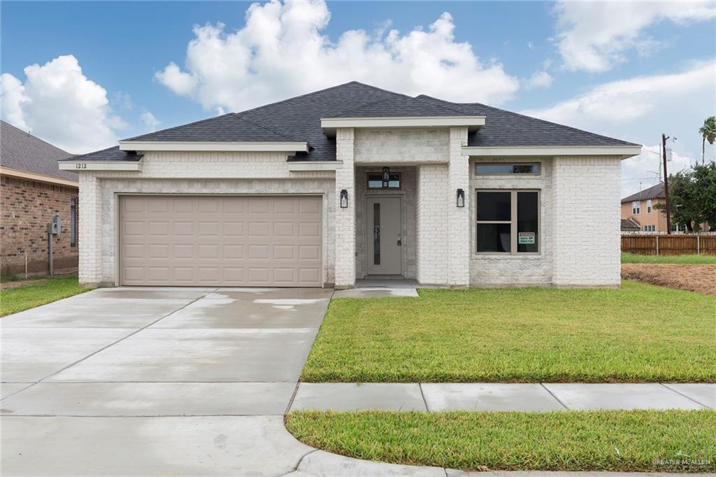 Prairie-style home featuring a garage and a front yard