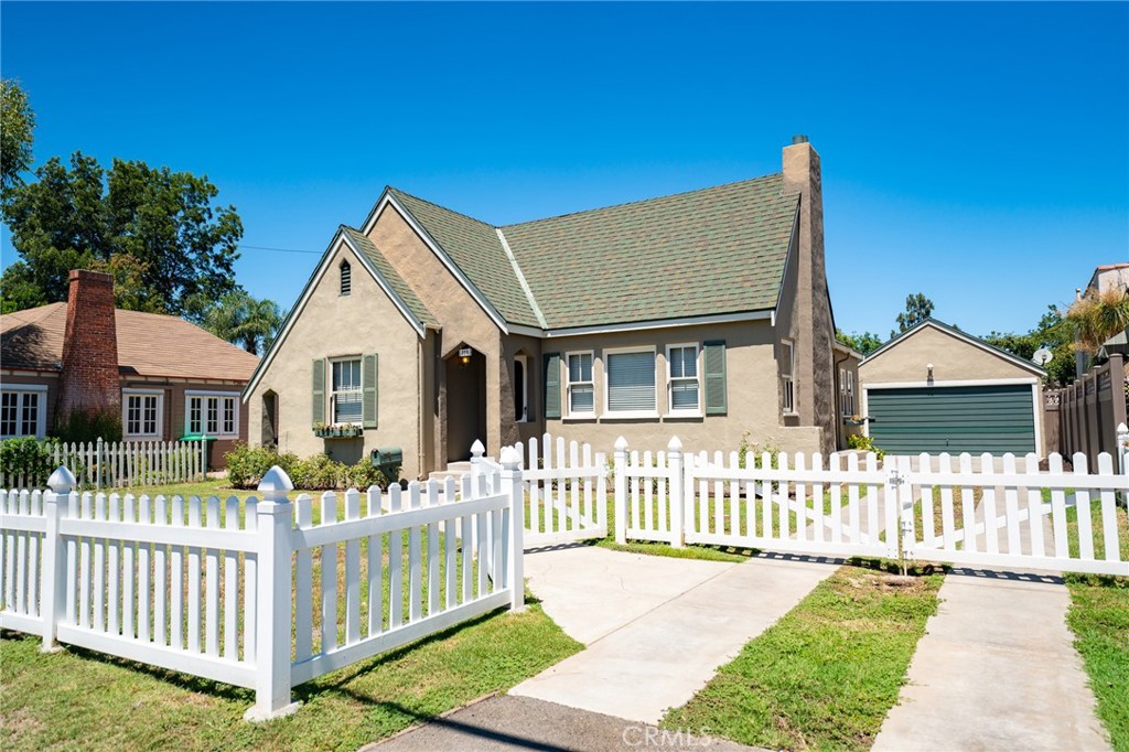 a front view of a house with wooden fence