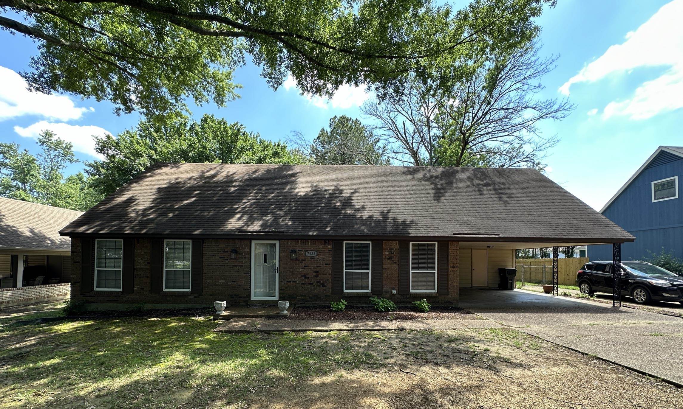 a front view of a house with a yard and outdoor seating