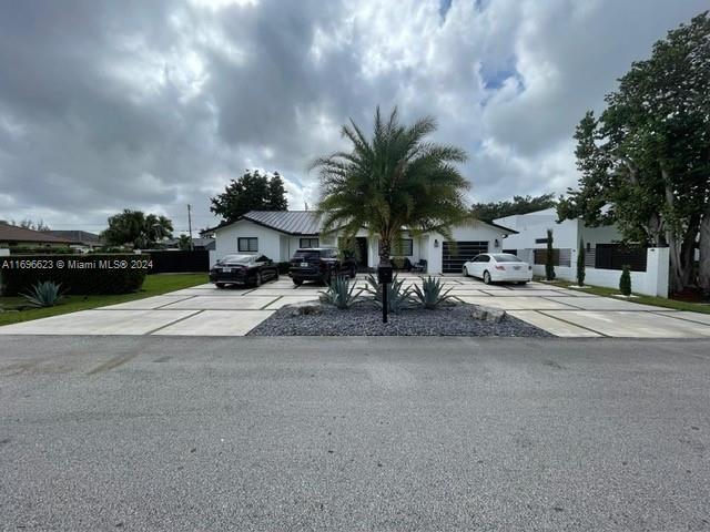 a row of palm trees in front of house