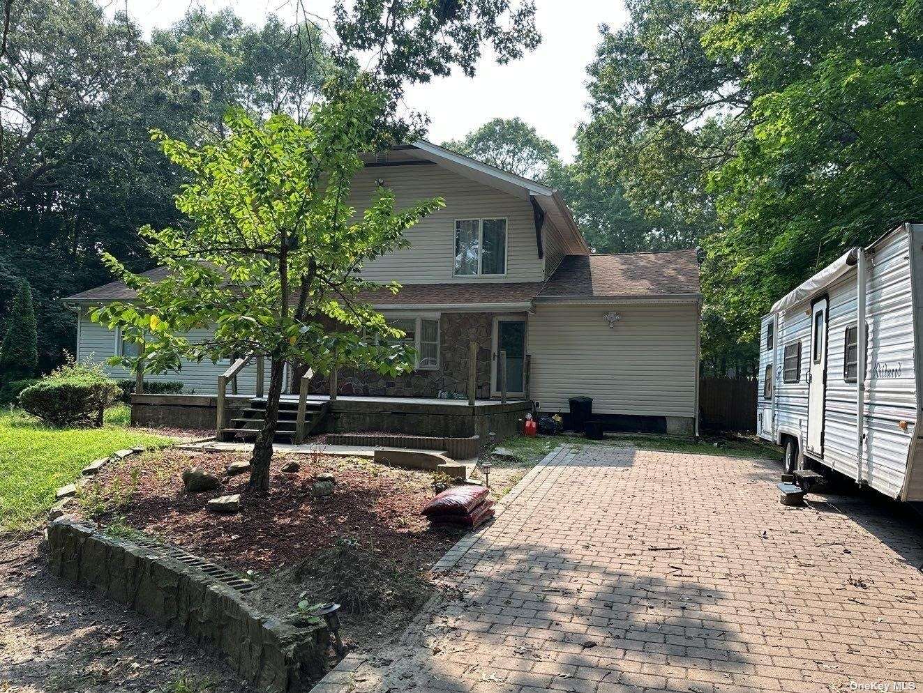 a view of a house with backyard sitting area and garden