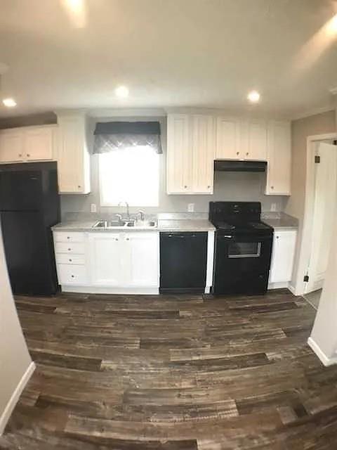 a view of kitchen with stainless steel appliances granite countertop a stove a sink and a refrigerator