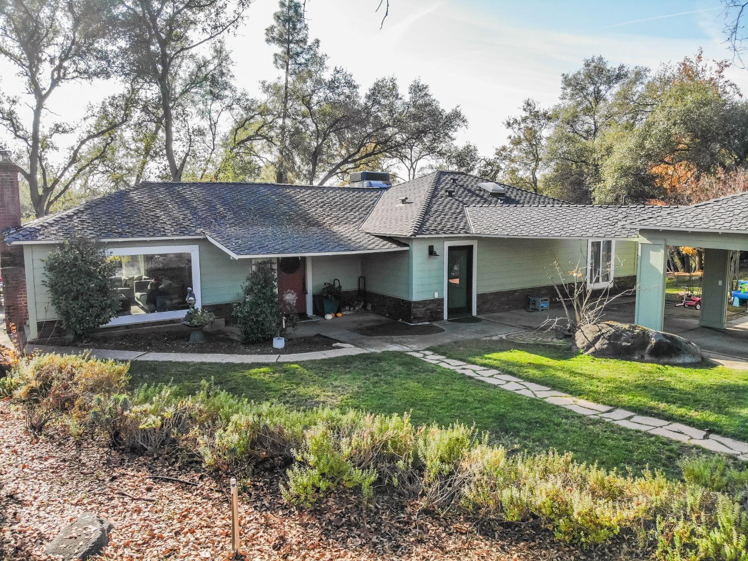 a view of a house with a yard patio and swimming pool