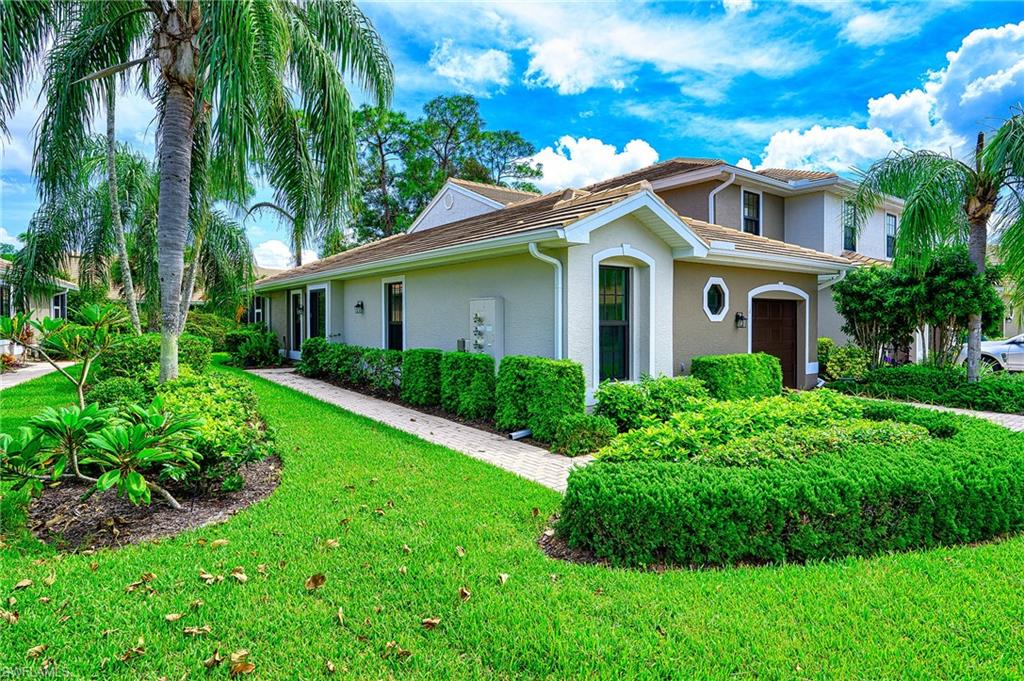 a front view of house with yard and green space