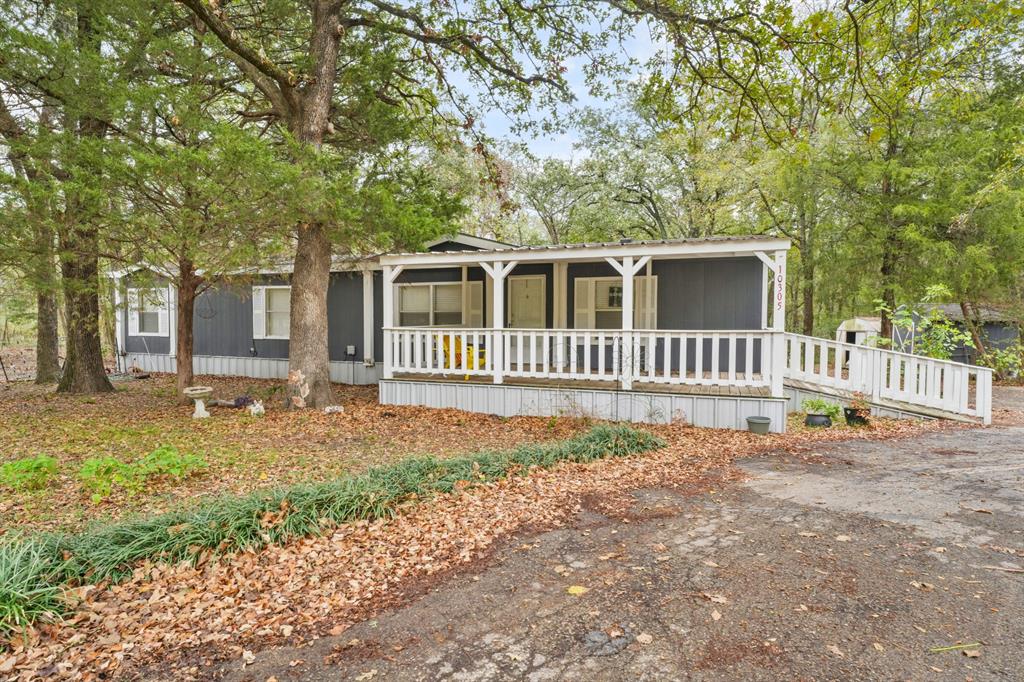 a view of a house with a backyard and a tree