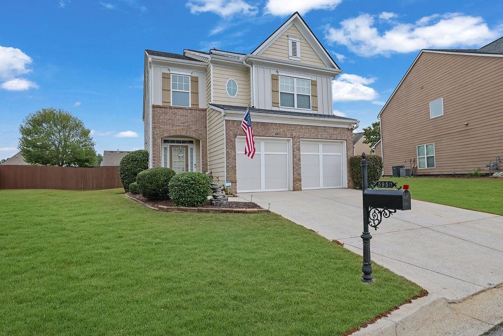 a front view of a house with a yard and garage