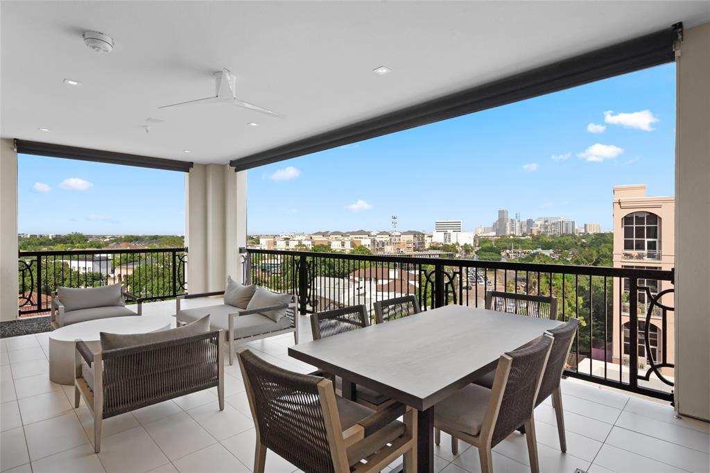 a view of a balcony dining table and chairs