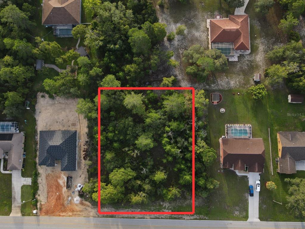 an aerial view of residential house with outdoor space and swimming pool