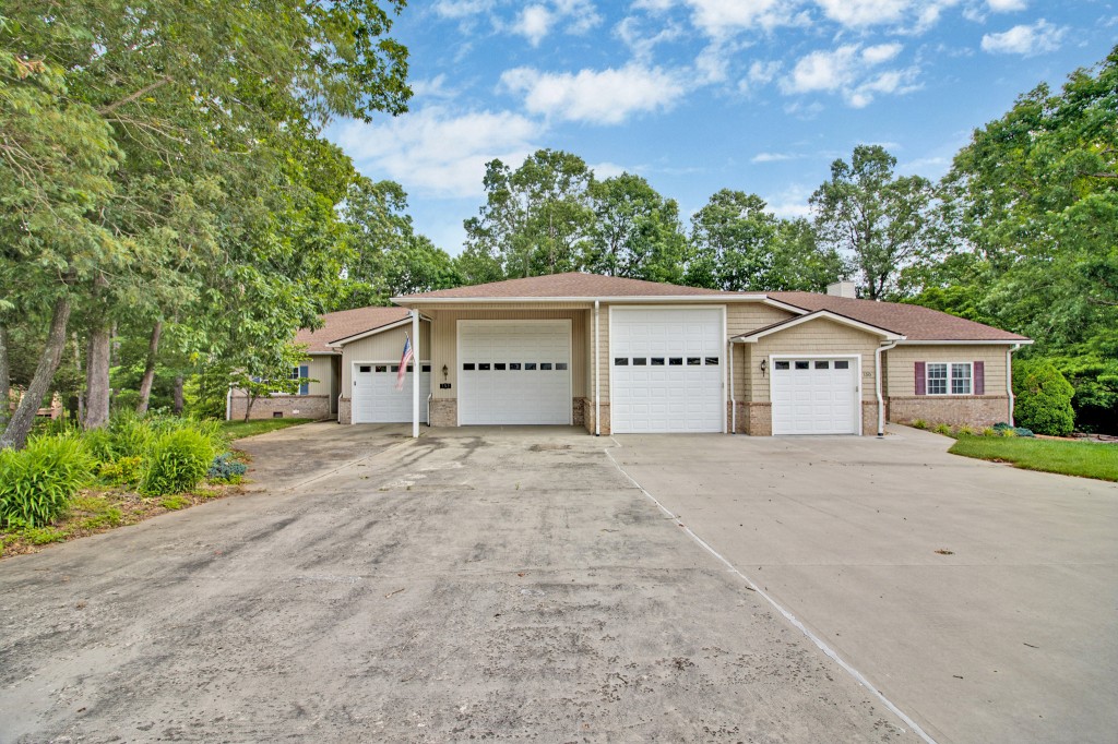 a front view of a house with a yard and trees