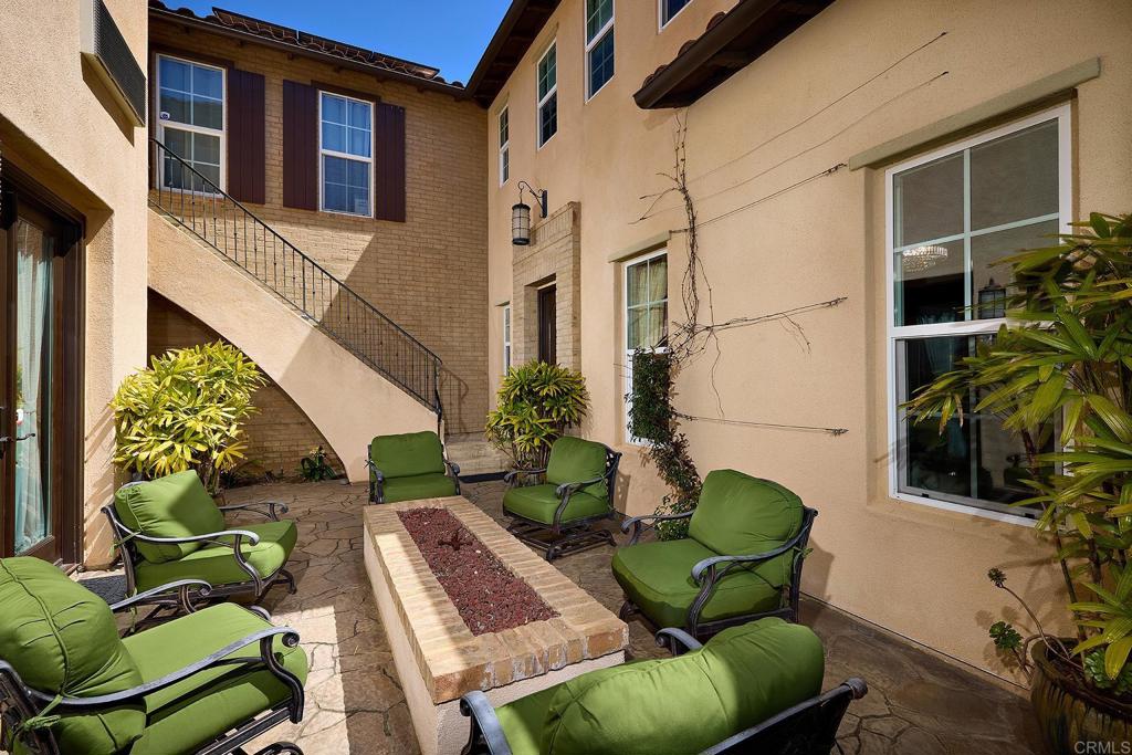 a view of backyard with outdoor seating and plants