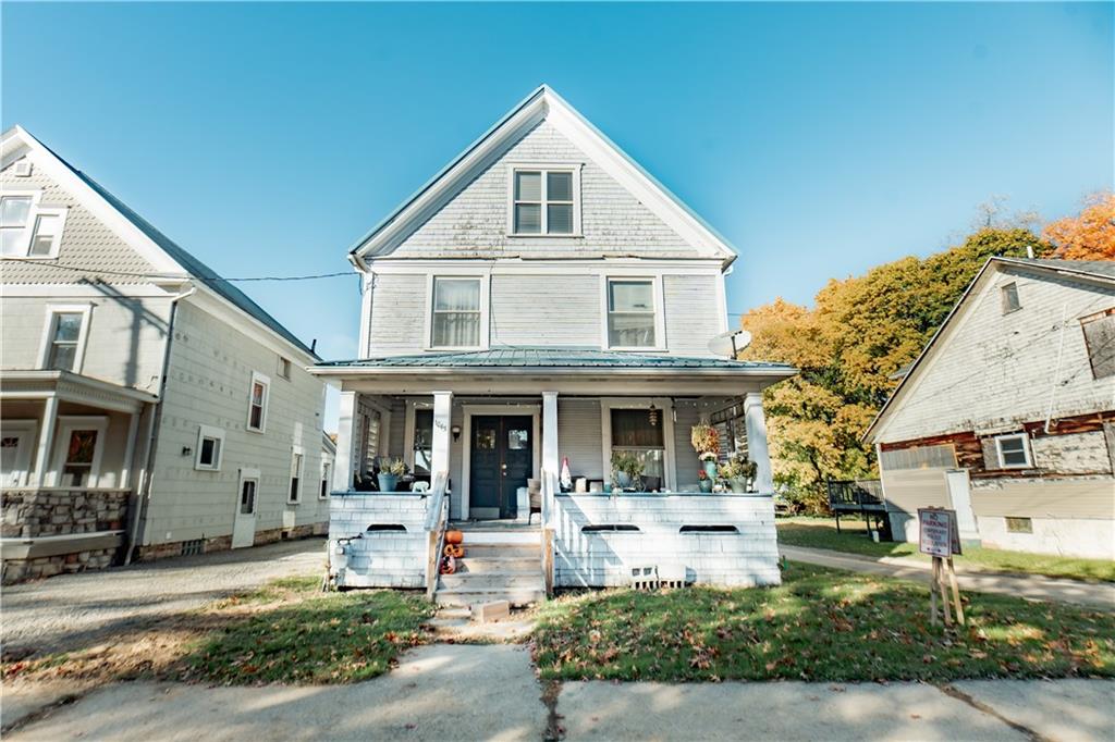 a front view of a house with garden and porch