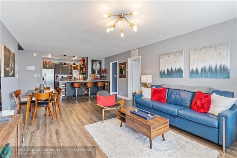 a living room with furniture and kitchen view