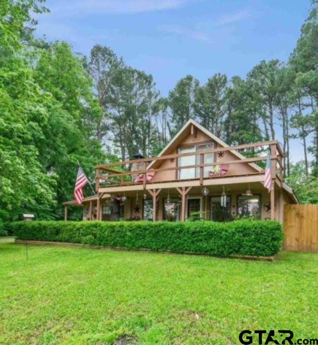 a very nice looking house with a big yard and large trees