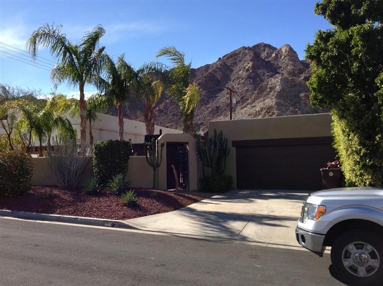 a view of a house with a yard and garage