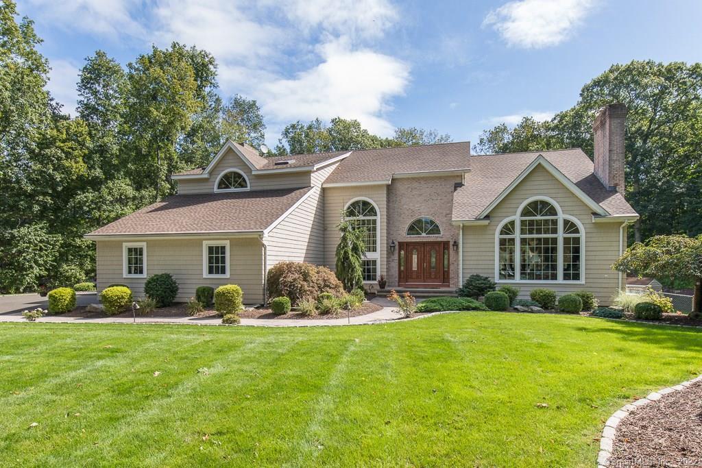 a front view of house with yard and green space