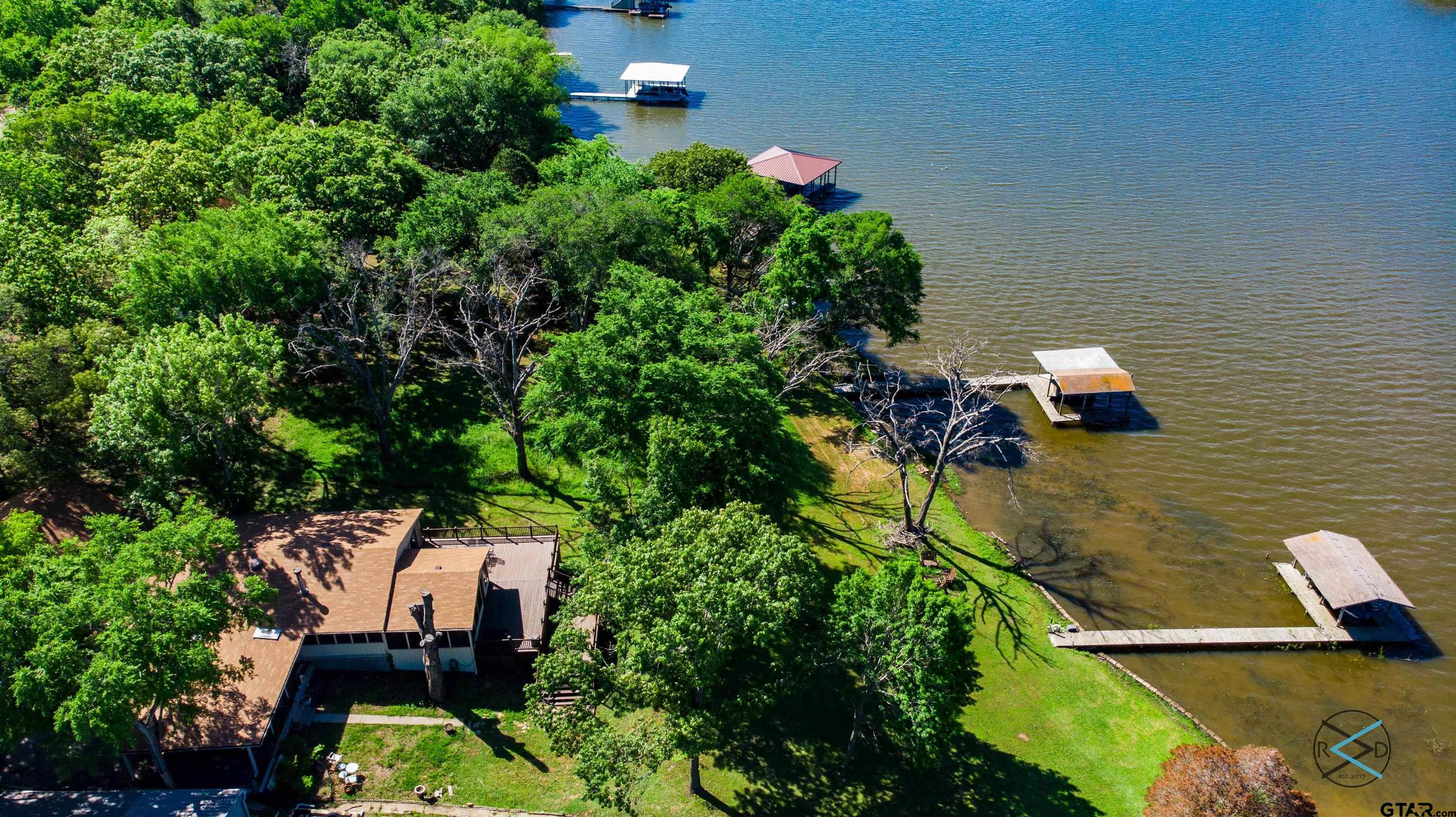 an aerial view of a house with a yard basket ball court and outdoor seating