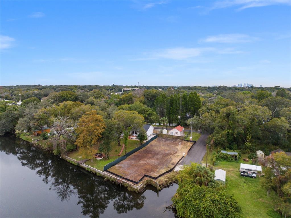 an aerial view of residential houses with outdoor space and trees