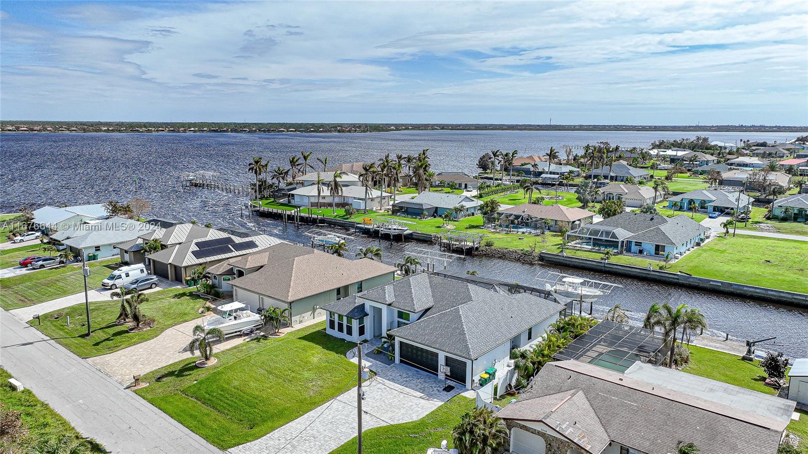 an aerial view of a house with a swimming pool patio and outdoor seating