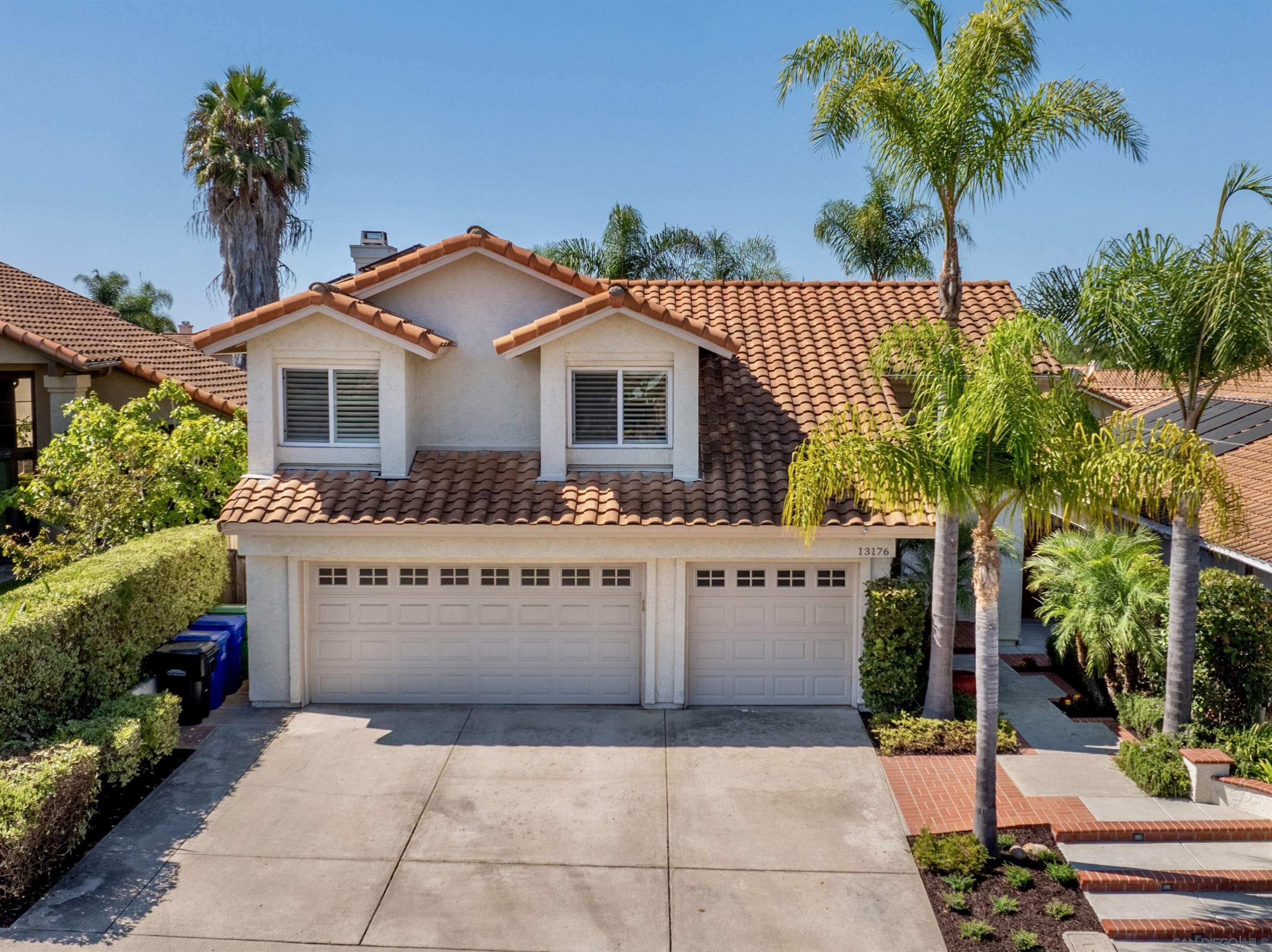 a view of house with palm trees