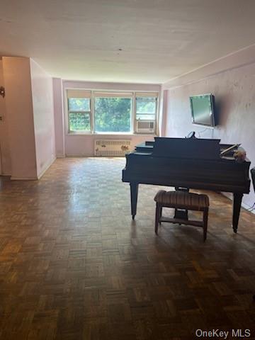 Misc room featuring radiator, cooling unit, and dark parquet floors