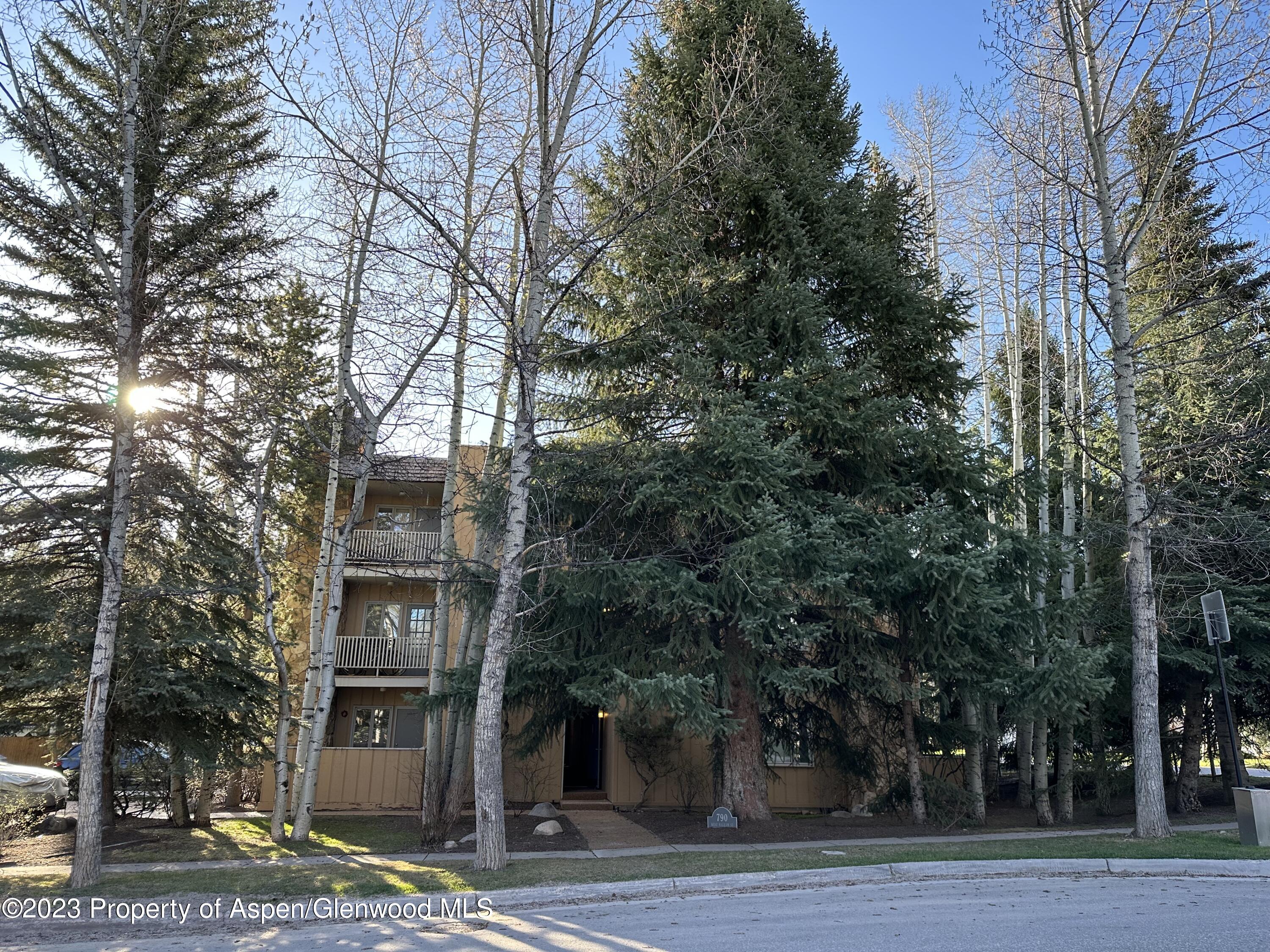 a tall building with trees in front of it