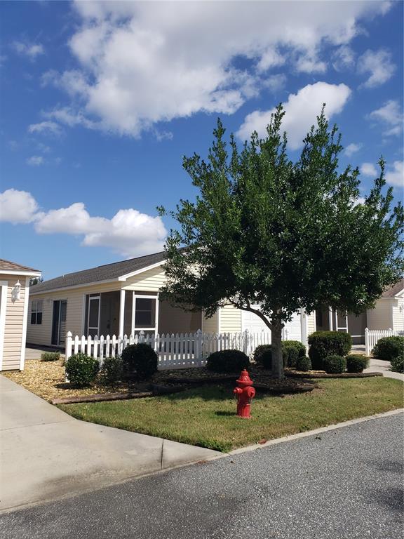 a view of a house with a yard and tree s