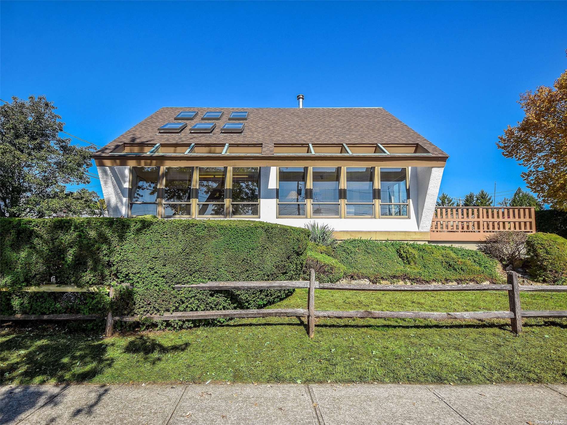 a front view of a house with a garden