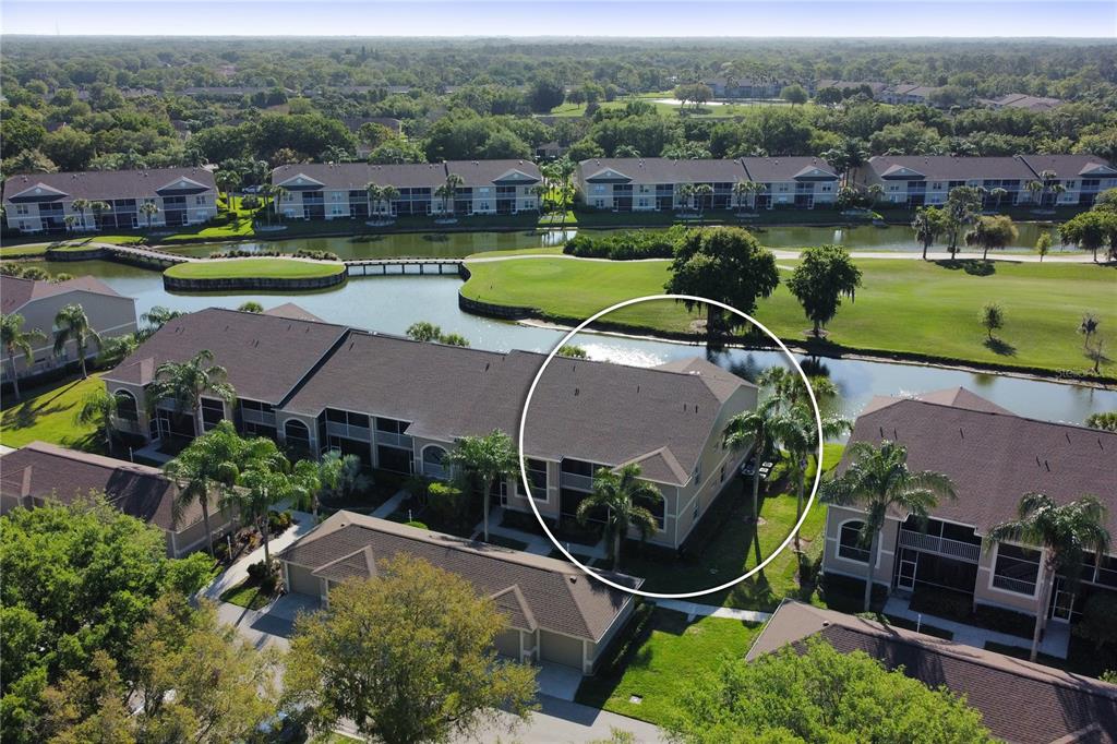 an aerial view of a house with a garden and lake view