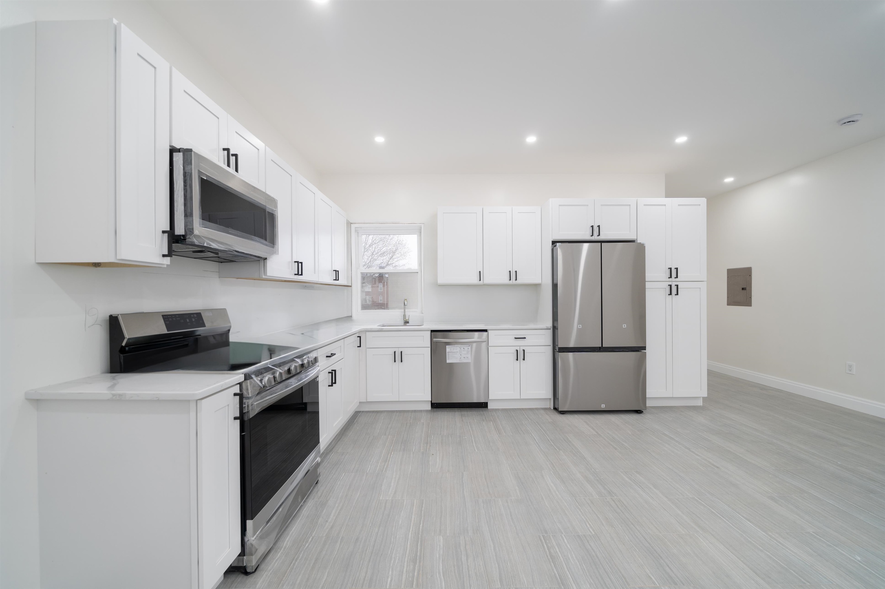 a kitchen with a white cabinets and white stainless steel appliances