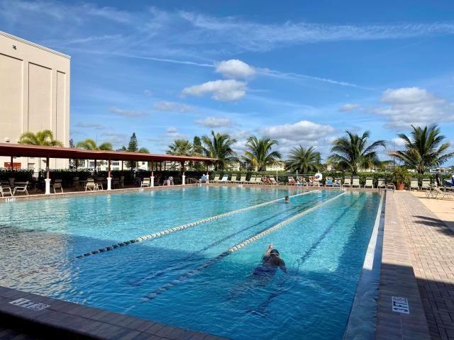 a view of a swimming pool with an outdoor space and seating area