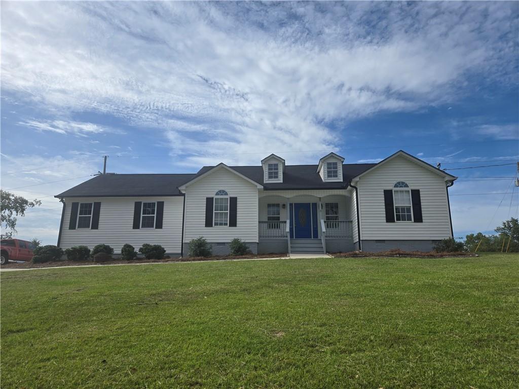 a front view of house with yard and green space