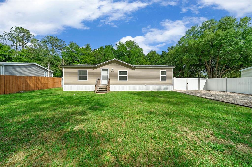 a view of a house with a yard and a garden