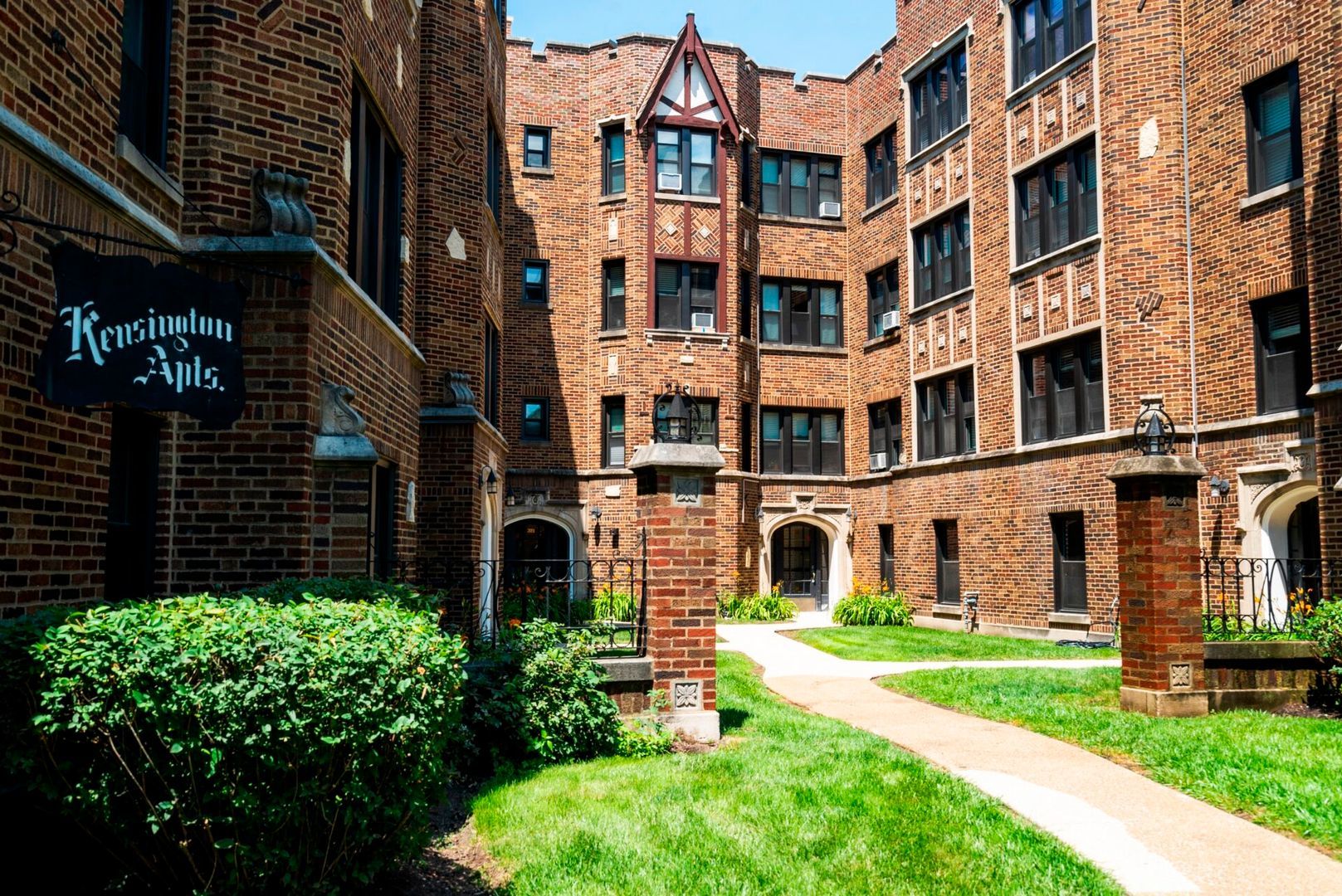 a view of a brick building next to a yard