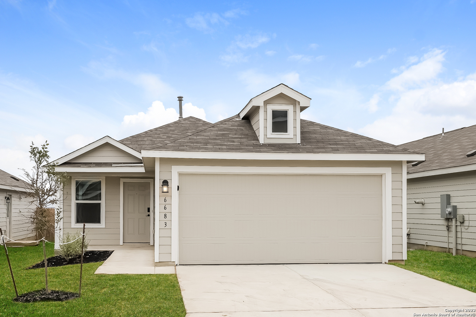 a front view of a house with a yard