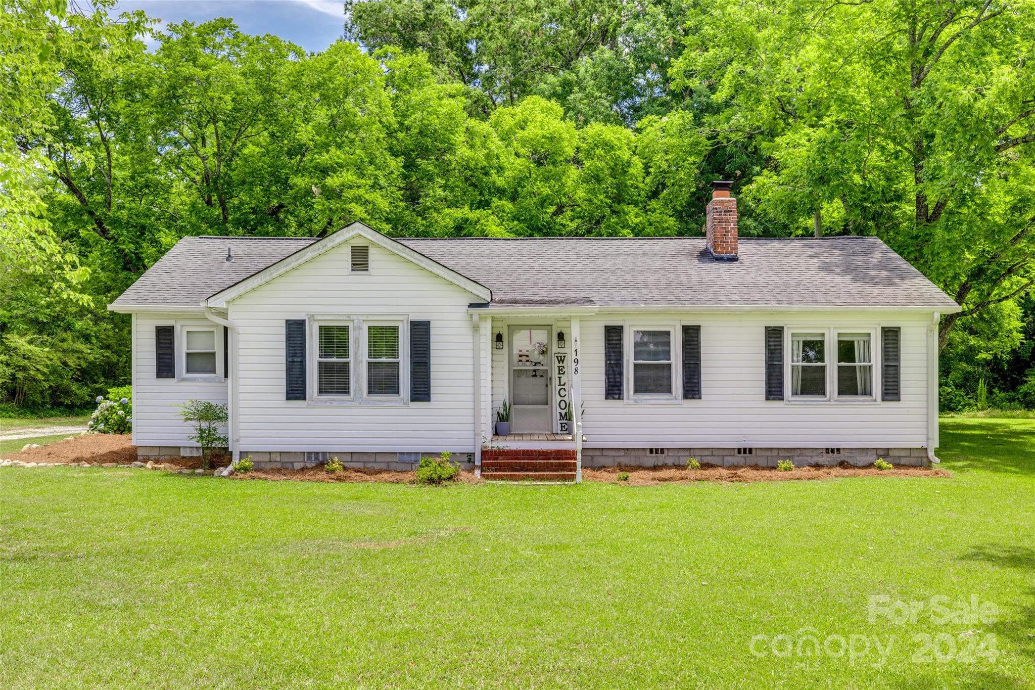 a front view of house with yard and green space