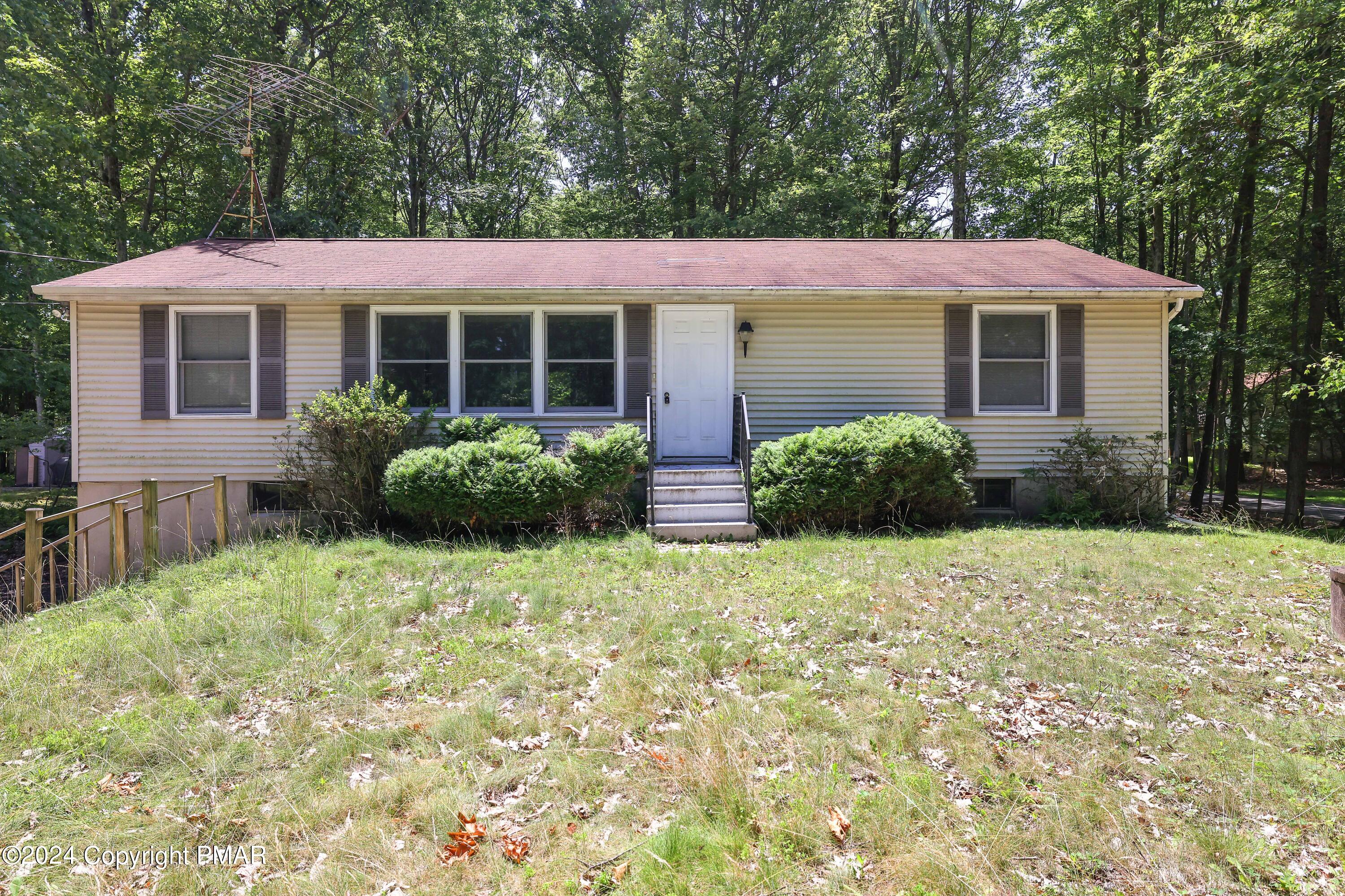 a front view of a house with garden