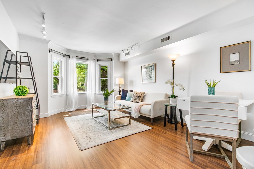 a living room with furniture and wooden floor