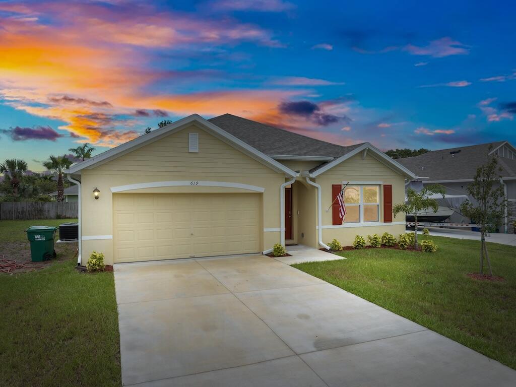 a front view of a house with a yard and garage