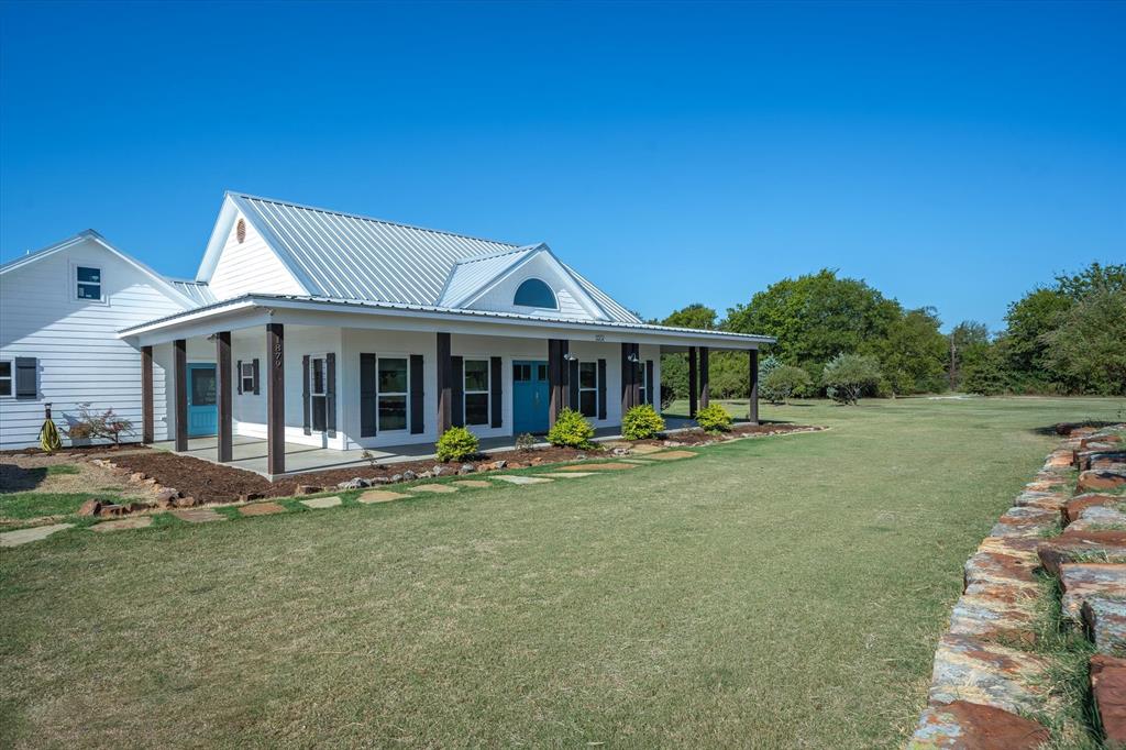 a front view of a house with garden and porch