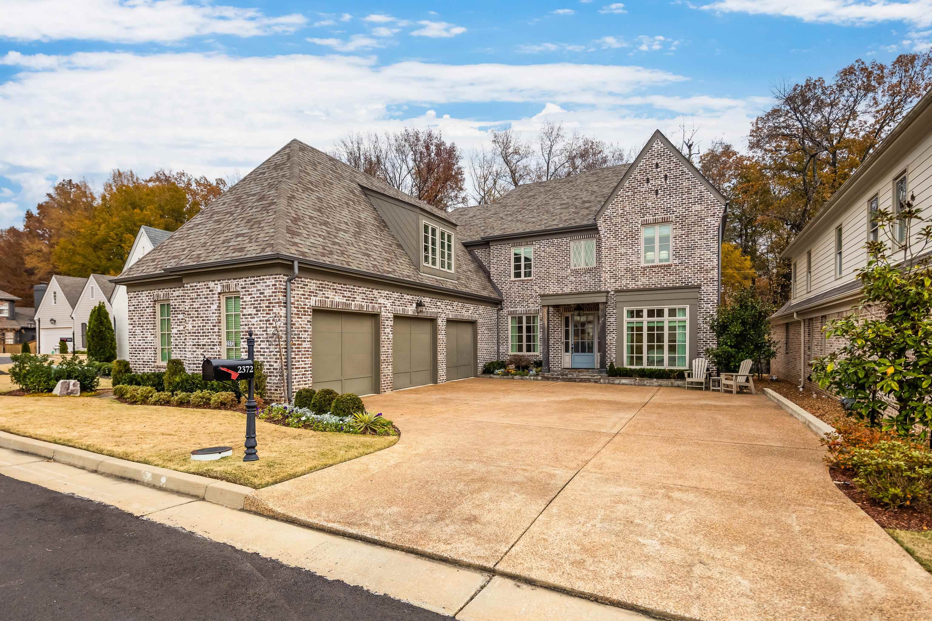 View of front of home featuring a garage and a front lawn