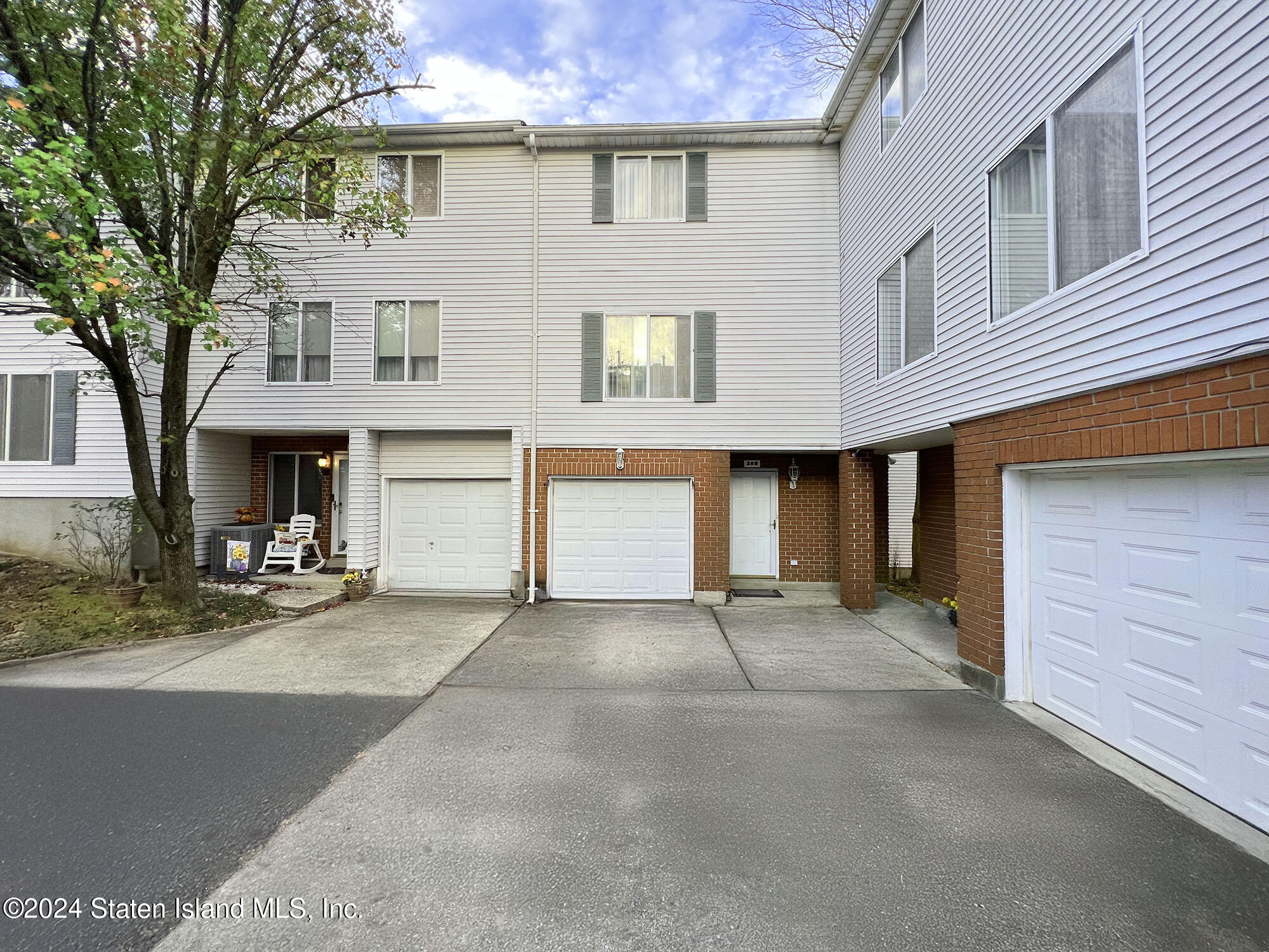 a view of a house with a street and a garage