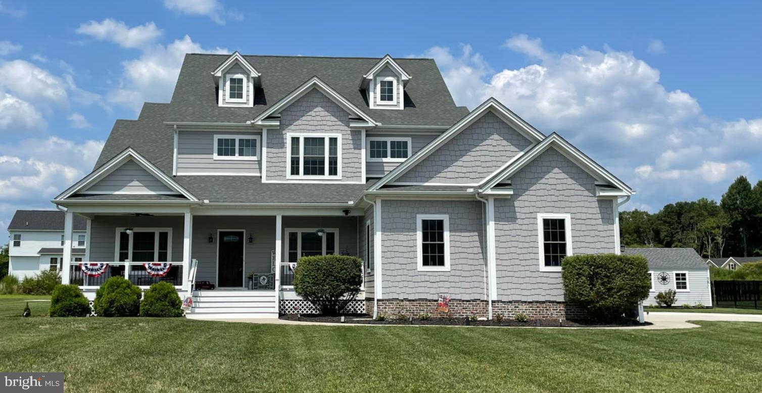 a front view of a house with a yard and porch