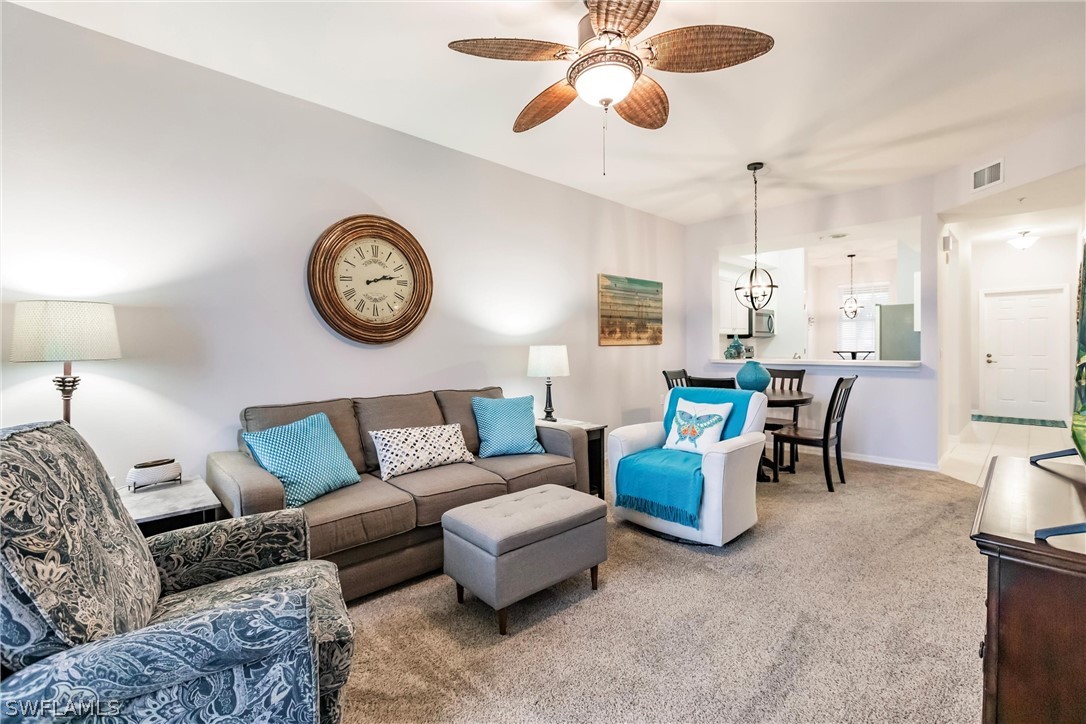 a living room with furniture a clock on wall and a table